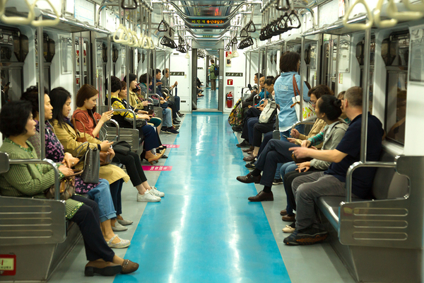 Inside a subway car with multiple people on board.